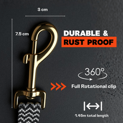 Gold clip for dog leash with measurement details on a dark background